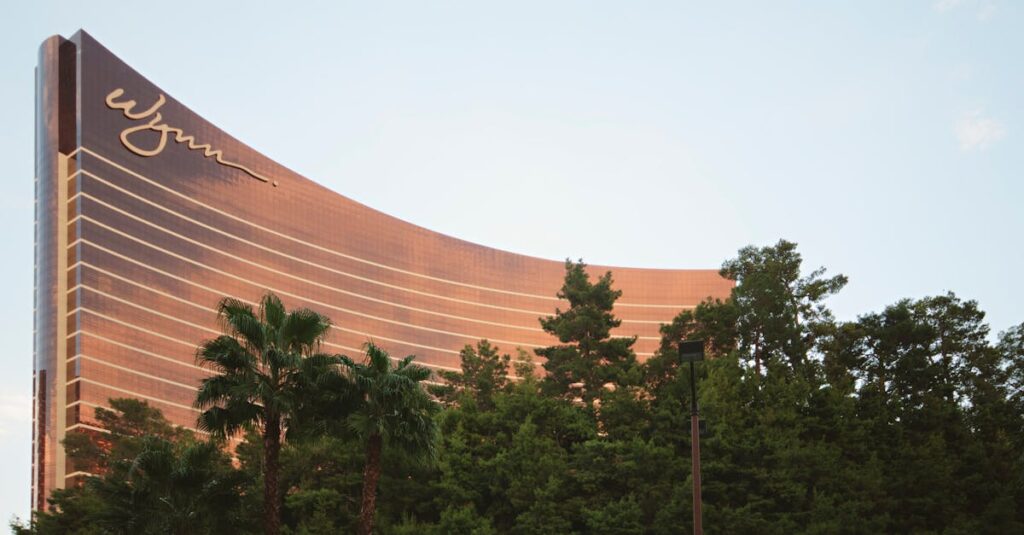 Stunning view of the Wynn Hotel in Las Vegas with greenery and a clear blue sky.